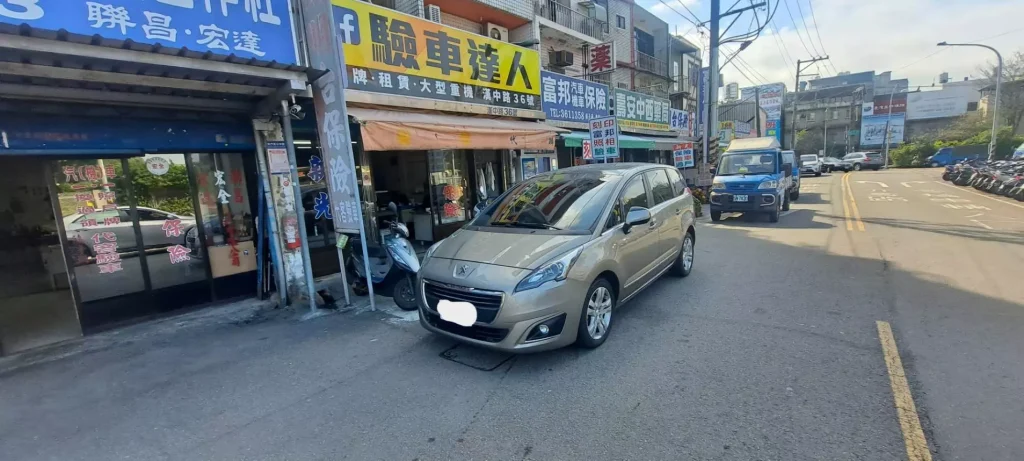 米色家庭用小客車停在驗車達人店前